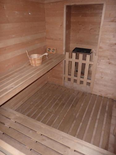 an inside of a sauna with a bucket at Pension Borůvka in Špindlerův Mlýn