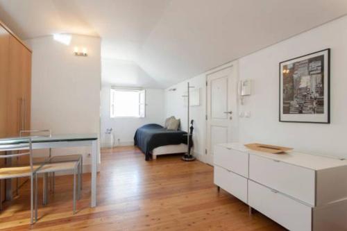 a living room with a table and a couch at Casas São Julião in Lisbon