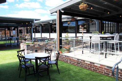 a patio with a table and chairs and a table and chairs at Mercure Orange in Orange