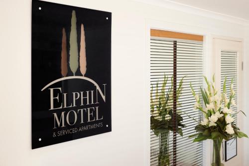 a white wall with a picture of a plant on it at Elphin Serviced Apartments in Launceston
