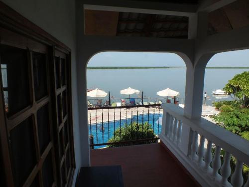 a balcony with a view of a swimming pool at Hôtel Kadiandoumagne in Ziguinchor