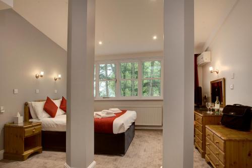 a bedroom with a bed and a sink in it at Best Western Andover in Andover