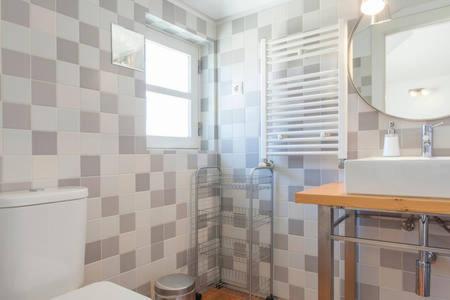 a bathroom with a toilet and a sink and a mirror at Casas São Julião in Lisbon