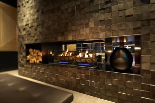 a brick wall with a fireplace with food in it at Shilla Stay Gwanghwamun Myeongdong in Seoul