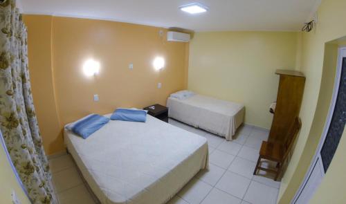 a small room with two beds in it at Hospedaje Jose Gorgues in Puerto Iguazú