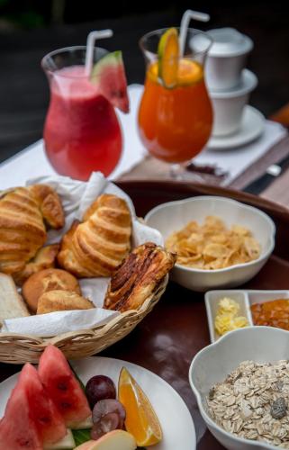 a table topped with bowls of breakfast foods and drinks at Villa Inle Boutique Resort in Nyaung Shwe