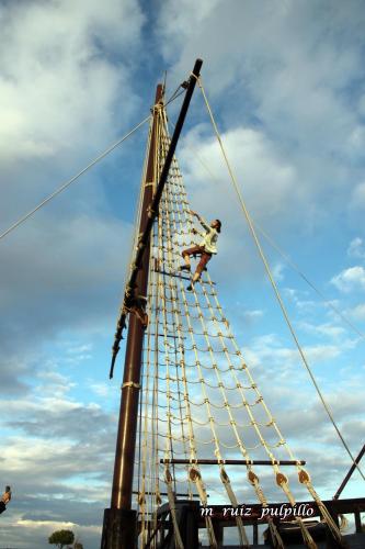 a man is on the top of a ship at Hostal Restaurante La Niña in Palos de la Frontera