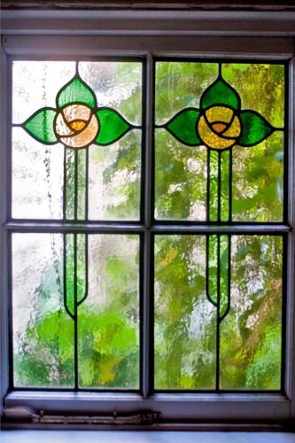 a window with three stained glass windows at Burnbank in Berwick