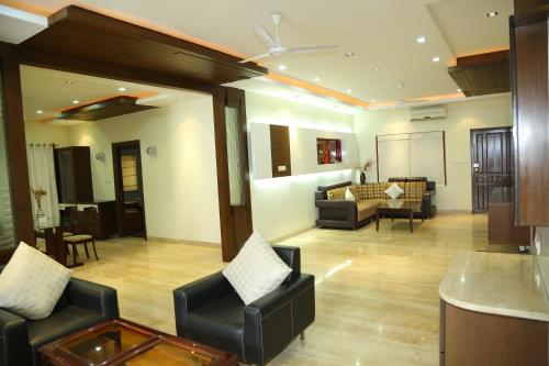a large living room with couches and a table at Swan Suites Madhapur in Hyderabad