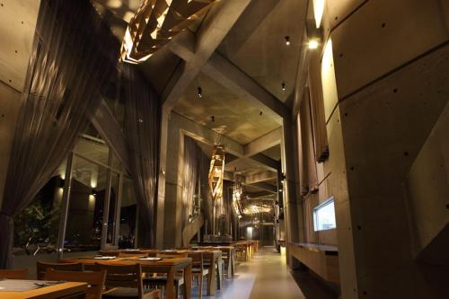 a dining room with tables and chairs and lights at Khokak Panoramas Hotel in Gukeng