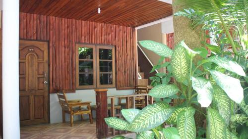 a room with a wooden door and some plants at Big Fish Resort Koh Tao in Koh Tao