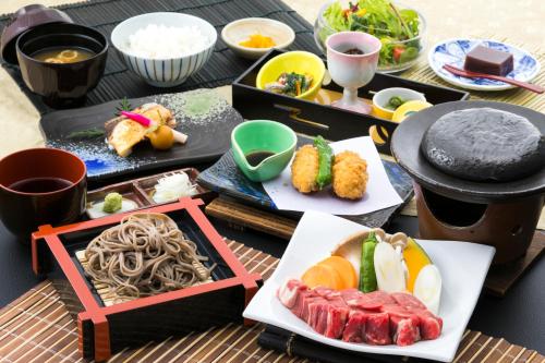 a table topped with different types of sushi and food at Sundance Resort Tateshina in Chino
