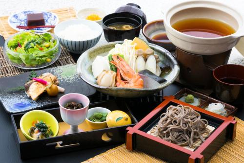 a table with a tray of food and bowls of food at Sundance Resort Tateshina in Chino
