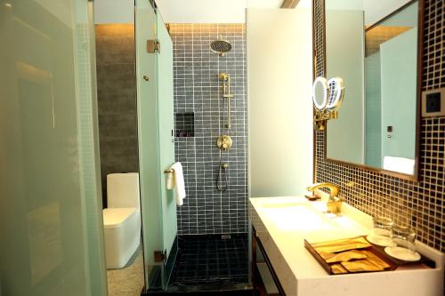 a bathroom with a sink and a shower at James Joyce Beijing Songjiazhuang Metro Station in Beijing