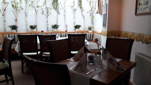 a dining room with tables and chairs and a window at Traumparadies in Bad Sulza