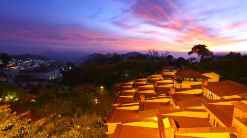 a group of umbrellas lined up on a hill at sunset at Kodai Resort Hotel, Kodaikanal in Kodaikānāl