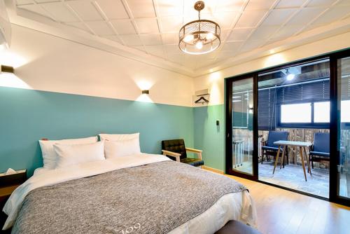 ウルサンにあるUlsan Hotel 109のベッドルーム1室(ベッド1台、テーブル、椅子付)