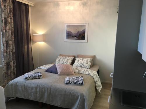 a bedroom with a bed with two pillows on it at Lahti City Home in Lahti