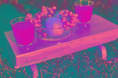 a wooden table with a bowl of fruit and two glasses at Mon Emvasia Margarites Villas in Margarítai