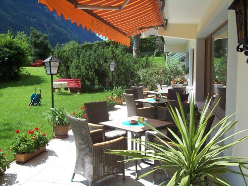 a row of tables and chairs on a patio at Pension Grein in Pfunds