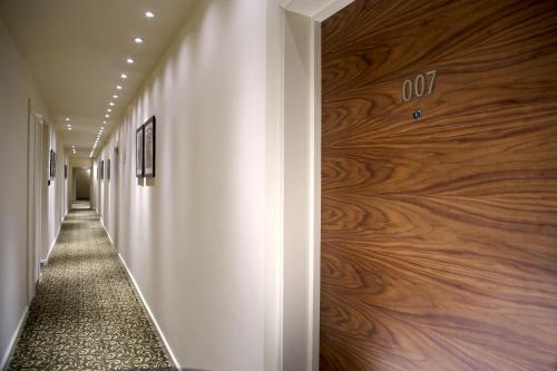 a hallway with a wall of wood at Blakemore Hyde Park in London