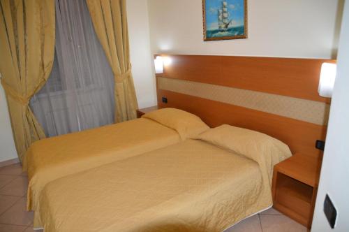 a small bedroom with a bed and a window at Hotel Moscatello in Rome