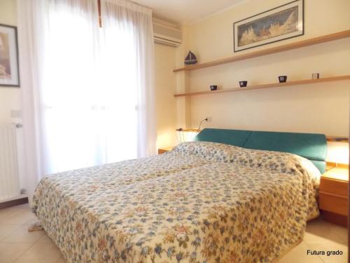 a bedroom with a bed and a large window at Residence Eleonora in Grado