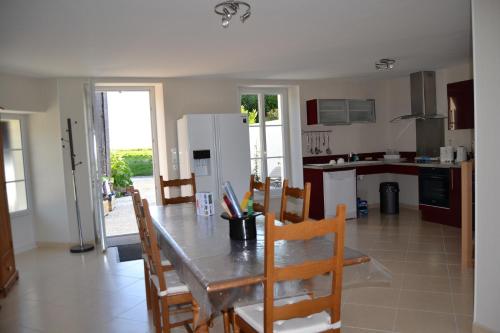 une cuisine et une salle à manger avec une table et des chaises dans l'établissement Gite Du Chai, à Chenac Saint Seurin D'uzet