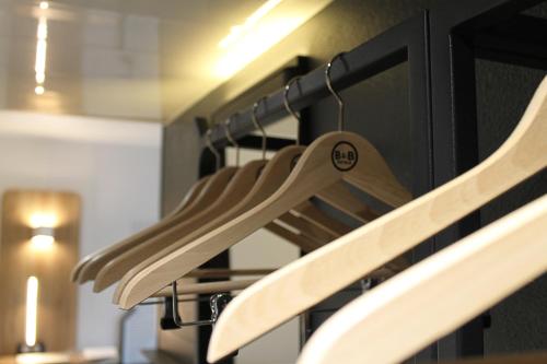 a row of wooden utensils hanging from an oven at B&B HOTEL LYON Centre Perrache Berthelot in Lyon