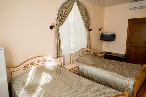Krevet ili kreveti u jedinici u okviru objekta Belovezhskaya Pushcha Hotel complex Zharkovshina
