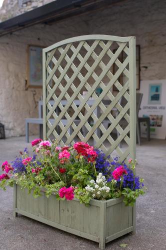 a wooden flower box with flowers in it at Cathedral View Apartments in Longford