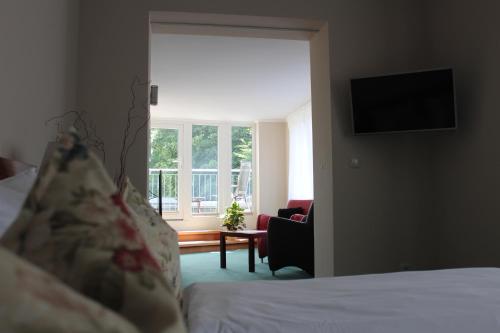 a hotel room with a bed and a window at Hotel Villa Passion in Malchow