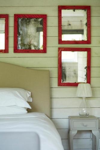 a bedroom with red framed windows and a bed at The Wheatsheaf Combe Hay in Bath