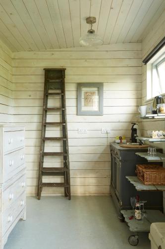 a kitchen with a ladder in the corner of a room at The Wheatsheaf Combe Hay in Bath