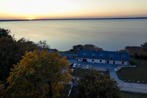 an aerial view of a building next to the water at Žvejų užeiga in Šiauliai