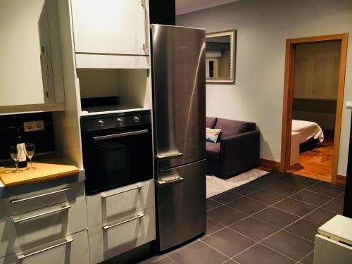 a kitchen with a large stainless steel refrigerator at Belem Aloja in Lisbon