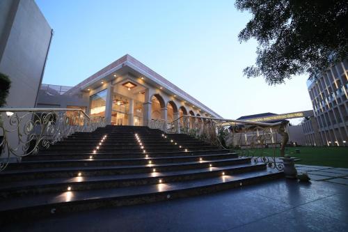a set of stairs with lights in front of a building at Southern Star,Davangere in Dāvangere