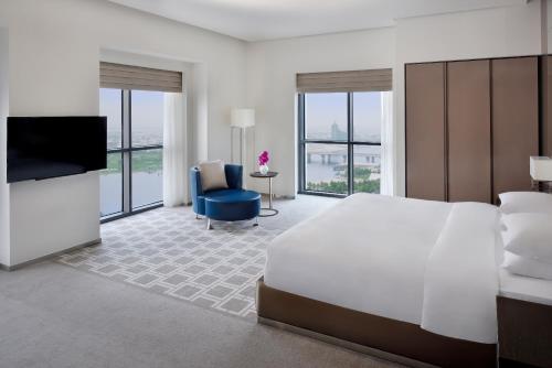 a hotel room with a large bed and a television at Hyatt Regency Creek Heights Residences in Dubai