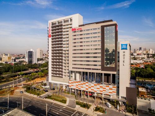 a tall white building with a sign on it in a city at ibis Sao Bernardo do Campo in São Bernardo do Campo
