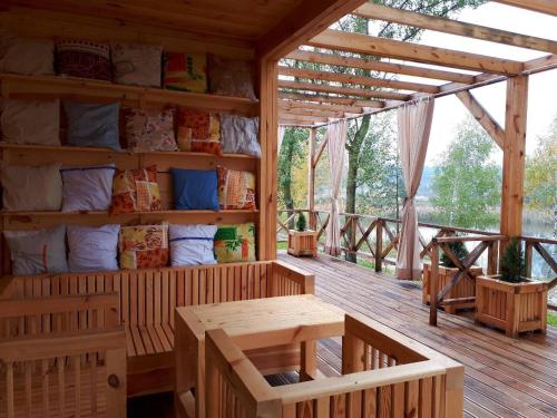 a wooden porch with a table and benches on a deck at Relax villa Poduzska in Sinyak