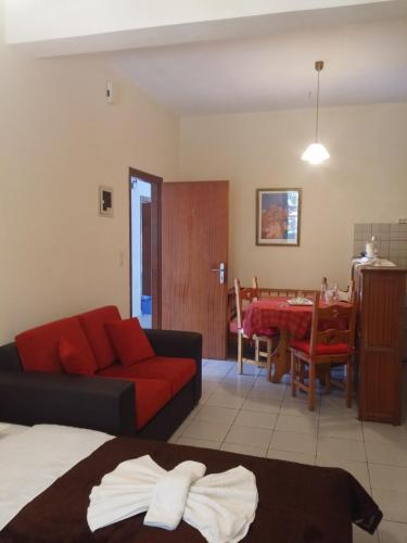 a living room with a couch and a dining room at Archontika Apartments in Kerames