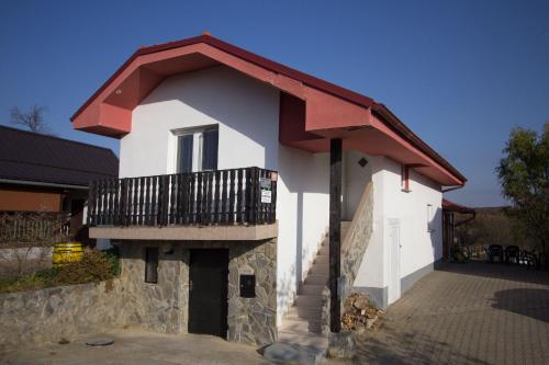 a building with a balcony on top of it at Holiday Home Janko in Bogojina