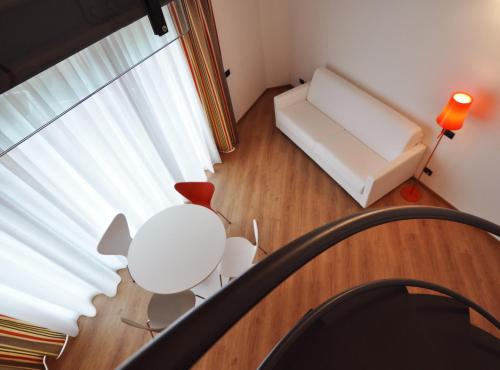 a living room with a white couch and a table at BB Hotels Aparthotel Isola in Milan