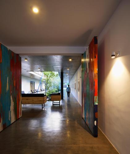 a hallway with paintings on the walls of a building at Serendiva Beach in Wadduwa