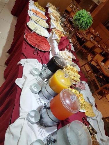 a long table with food and drinks on it at Hotel Atlântico Business Centro in Rio de Janeiro