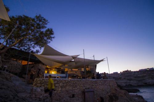 a building with a tent with people standing outside at Relais Isole del Sud in Lampedusa