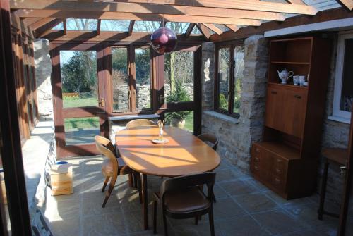 a room with a table and chairs on a patio at The Old Reading Room in Kingston