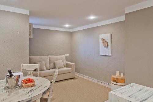 a living room with a couch and a table at Hotel Luze El Toro in Berrioplano