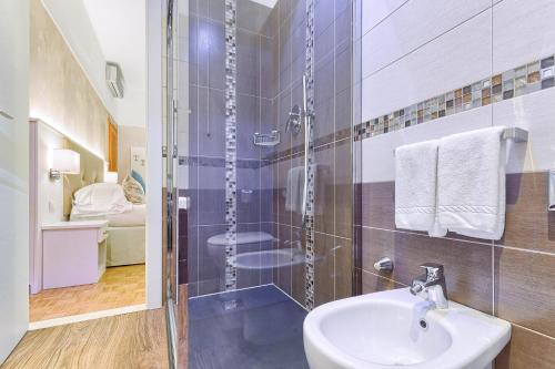 a bathroom with a sink and a glass shower at Hotel Monte Rosa in Chiavari
