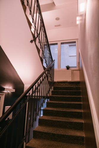 a flight of stairs in a building with a window at Hotellux B&B in Zagreb